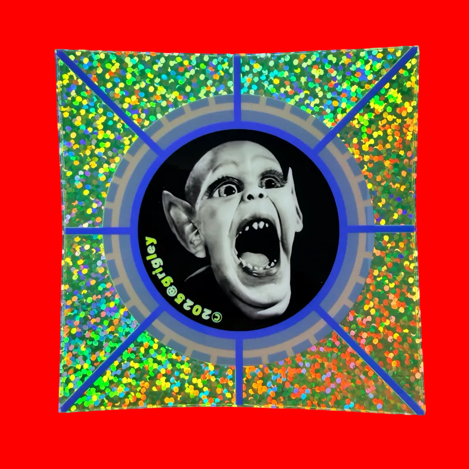 Canvas print with a colorful border featuring a black and white image of a screaming Bat Boy face in the center. 