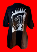 Black tee shirt with an artistic drawing of a kings face n white ink. The background is red.