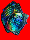 Holographic sticker with 'God Save America' text on a wooden surface