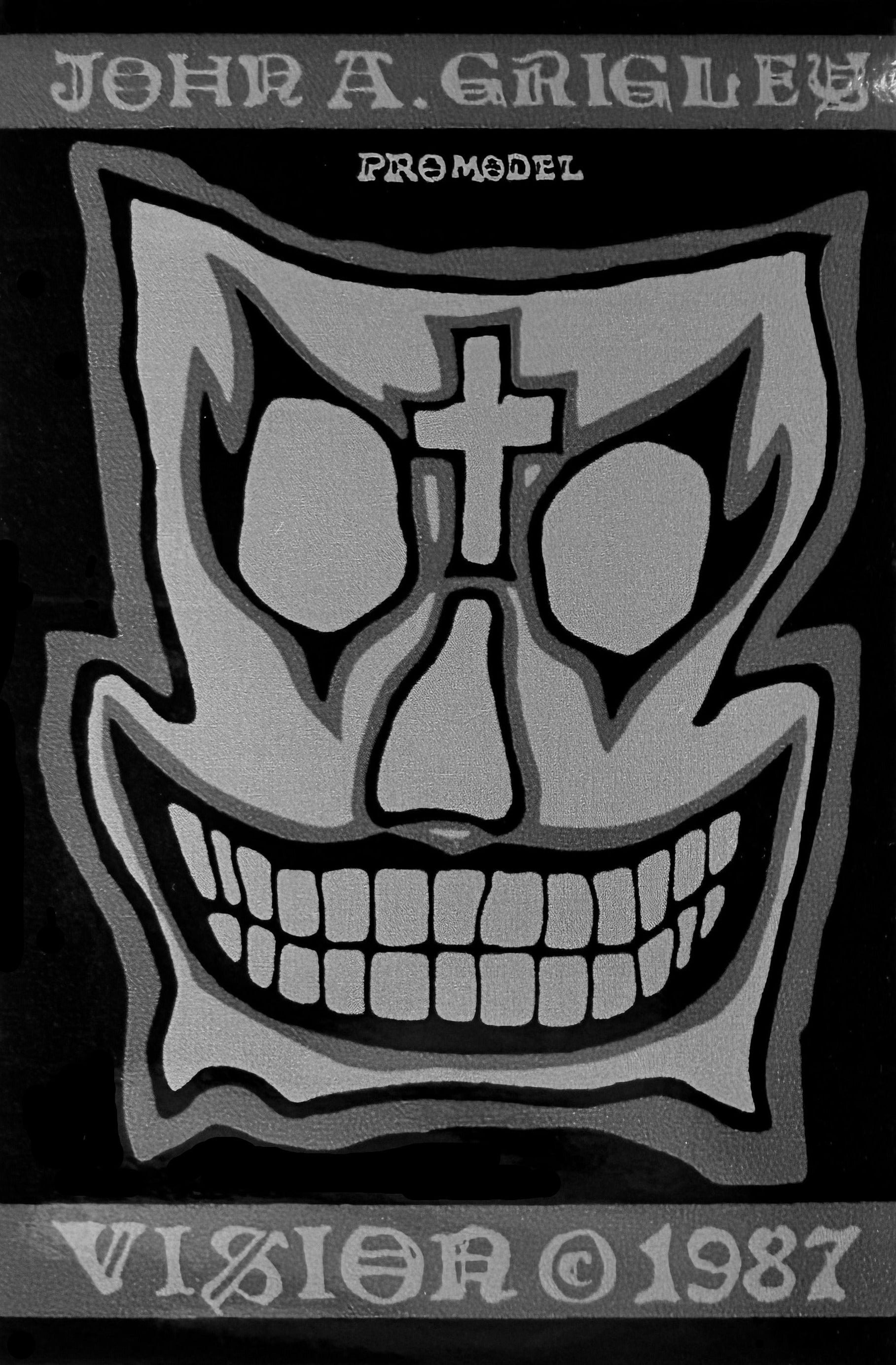 Stylized skull design with cross on a black background, featuring the text 'John A. Grigley' and 'VISION 1987'.