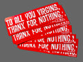 Stack of red stickers with white text on a textured surface