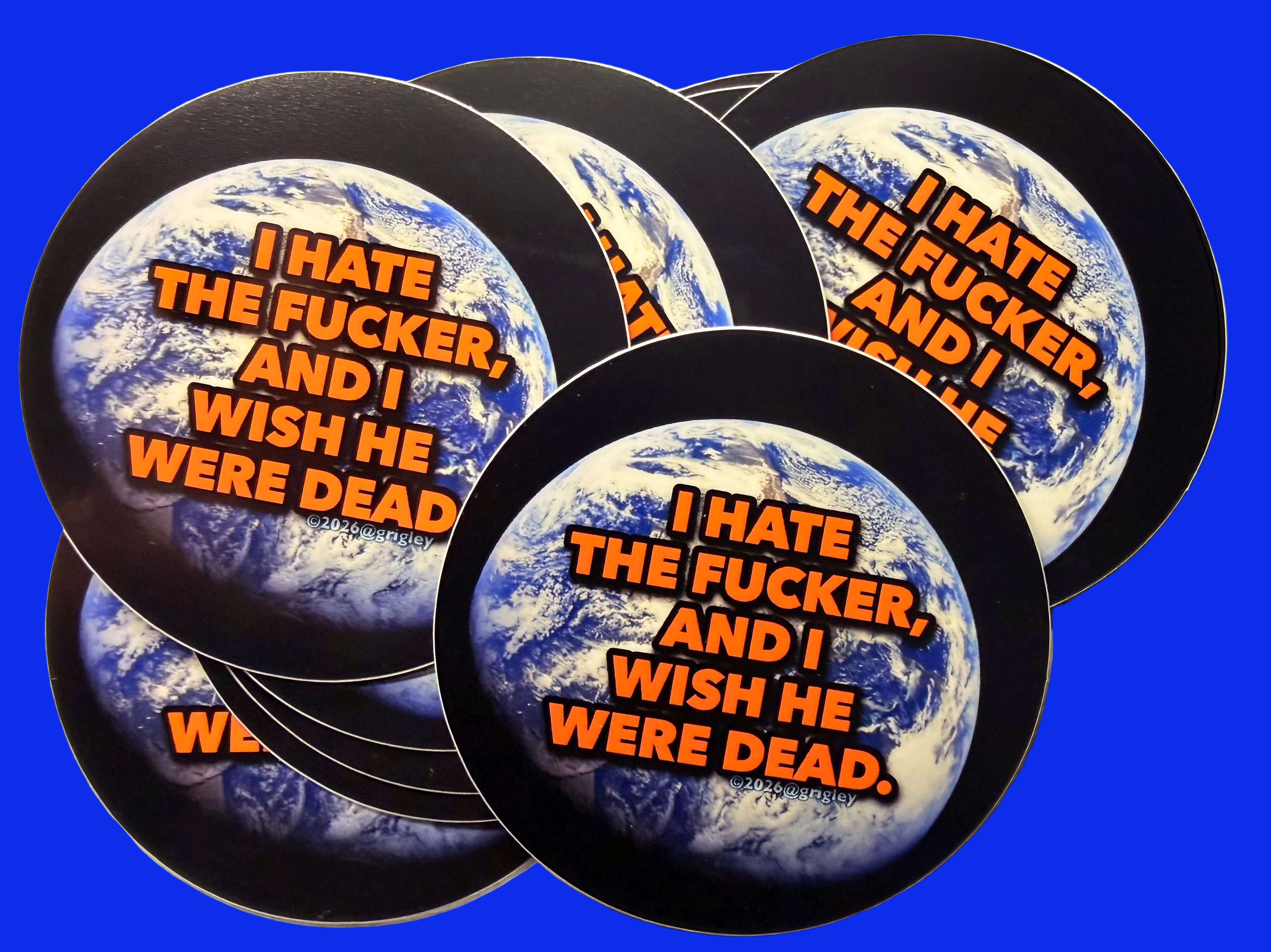 Stickers with a graphic design and text on a textured surface