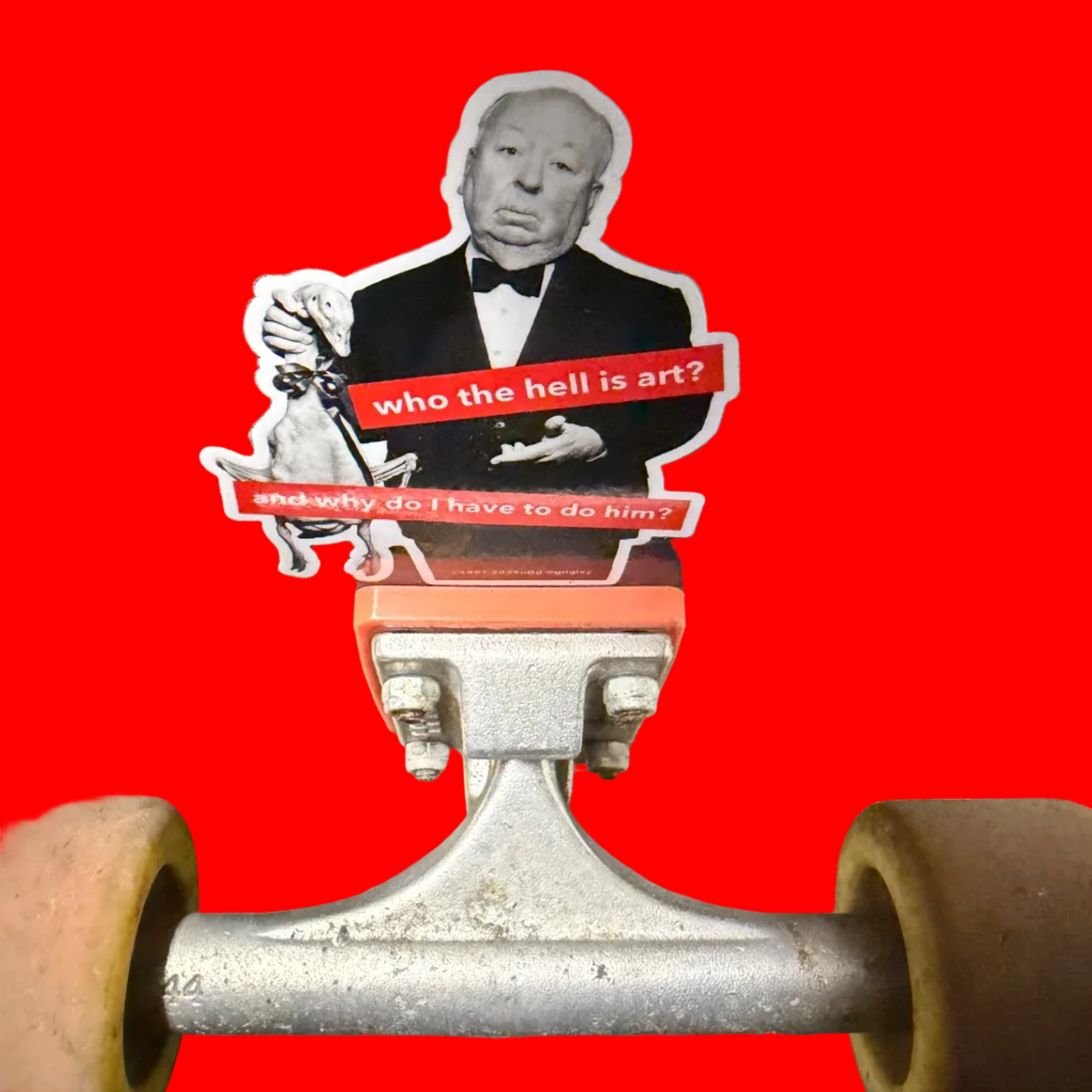 Skateboard with a sticker of a famous artist and text on a dark surface.
