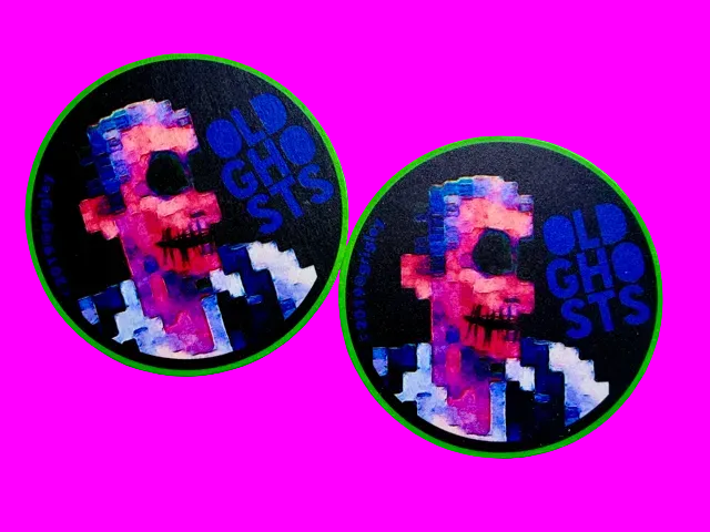 Two round stickers with pixelated design and 'OLD GHO STS' text on a light gray background.